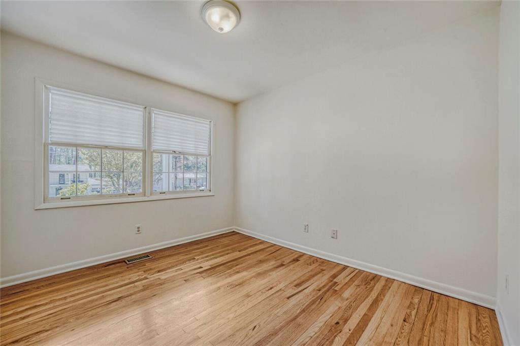 2754 Esquire Way Tucker, GA 30084 - Photo 30 of 49 wooden floor in an empty room with a window