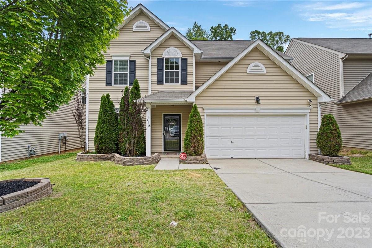 412 Rook Road Charlotte, NC 28216 - Photo 1 of 40 a front view of a house with a yard and garage