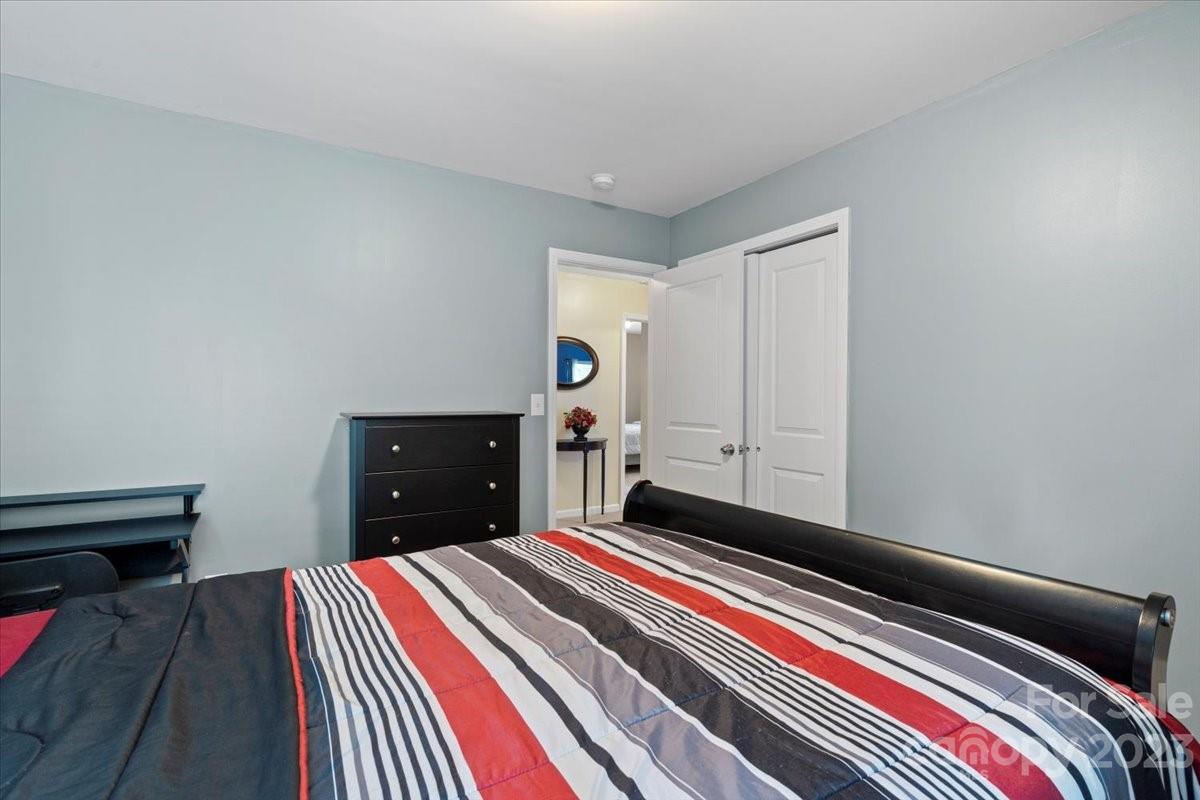 412 Rook Road Charlotte, NC 28216 - Photo 29 of 40 a bedroom with a bed and a dresser