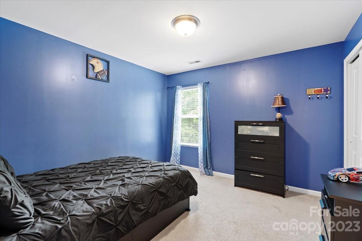 412 Rook Road Charlotte, NC 28216 - Photo 33 of 40 a bedroom with a bed and a dresser