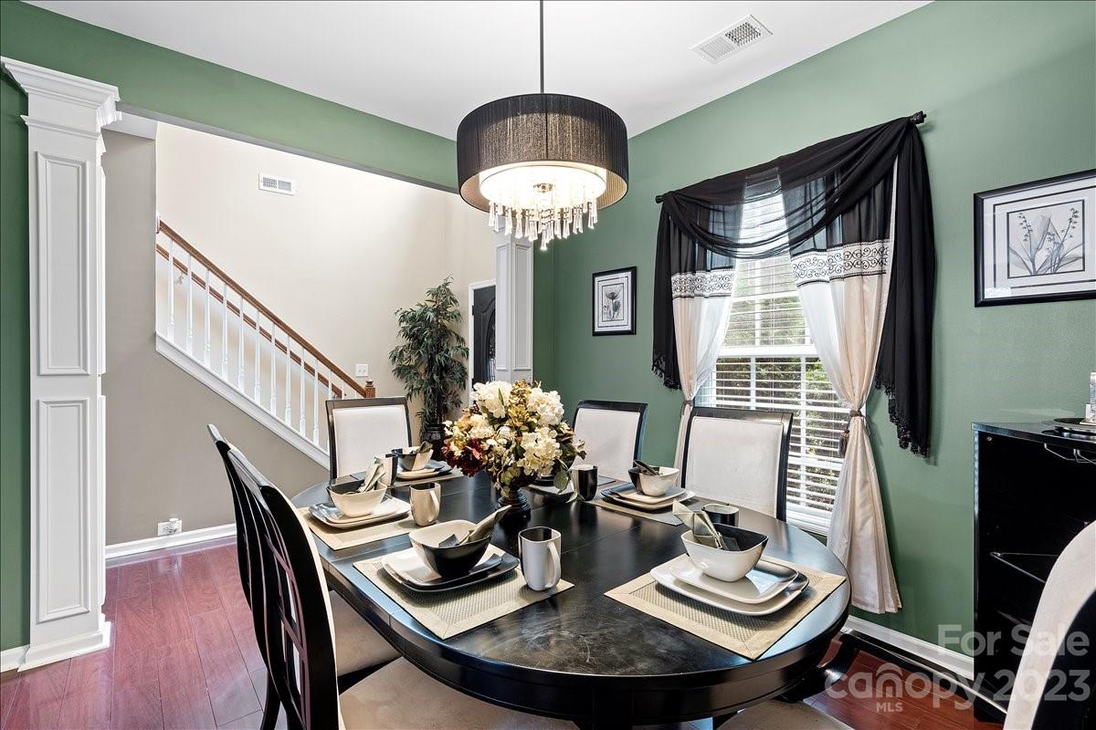 412 Rook Road Charlotte, NC 28216 - Photo 7 of 40 a dining room with furniture a chandelier and wooden floor