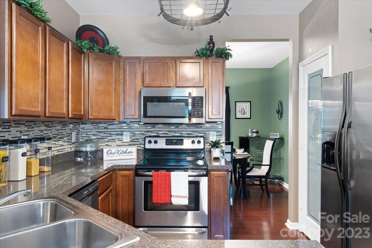 412 Rook Road Charlotte, NC 28216 - Photo 8 of 40 a kitchen with stainless steel appliances granite countertop a sink and a refrigerator