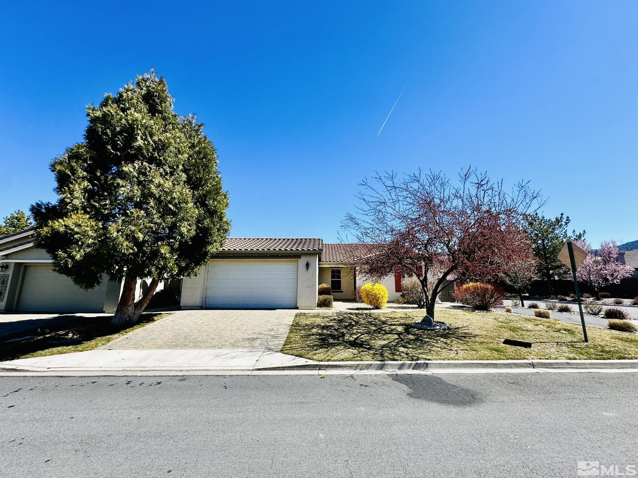 491 Oldenburg Drive Reno, NV 89521 - Photo 1 of 36 a front view of a house with a yard and garage