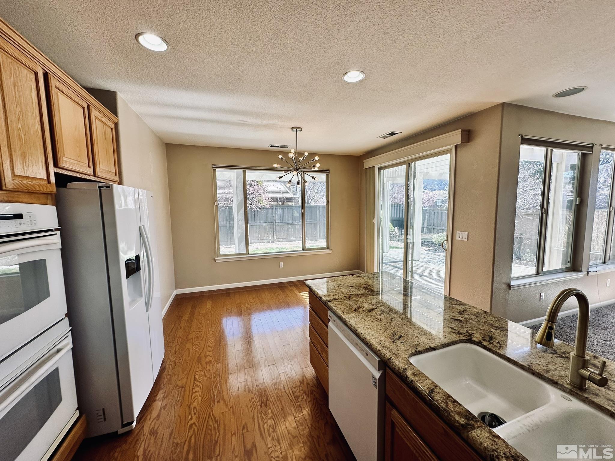 491 Oldenburg Drive Reno, NV 89521 - Photo 11 of 36 a bathroom with a granite countertop sink and a large mirror