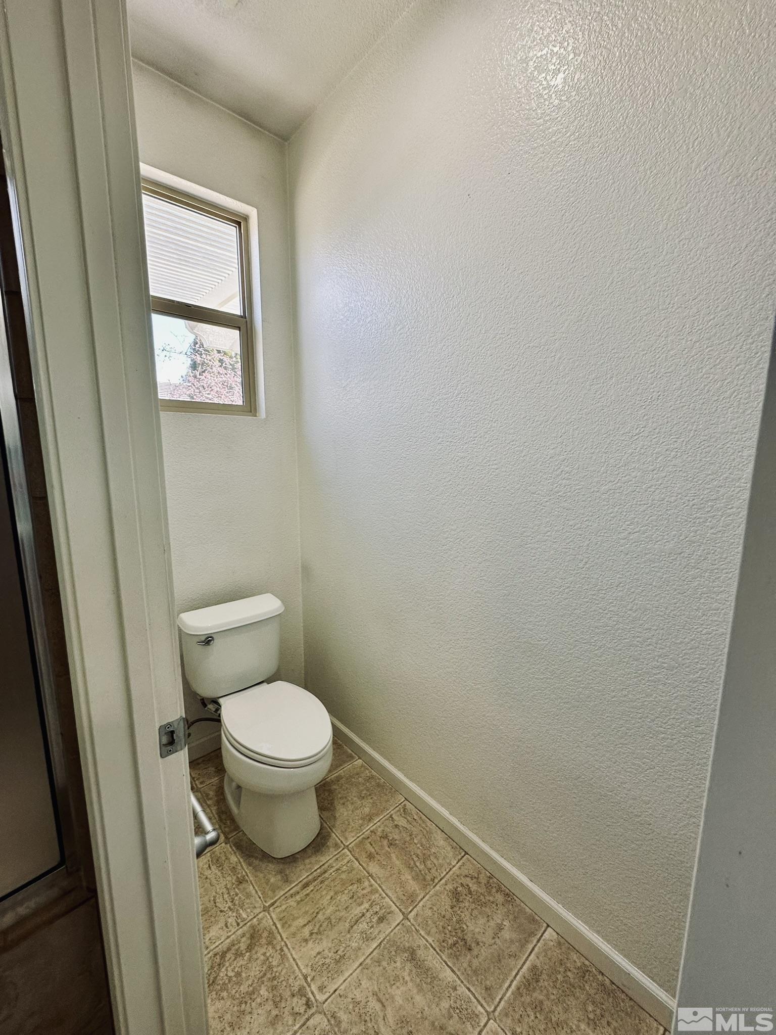 491 Oldenburg Drive Reno, NV 89521 - Photo 23 of 36 a toilet sitting in a bathroom next to a sink