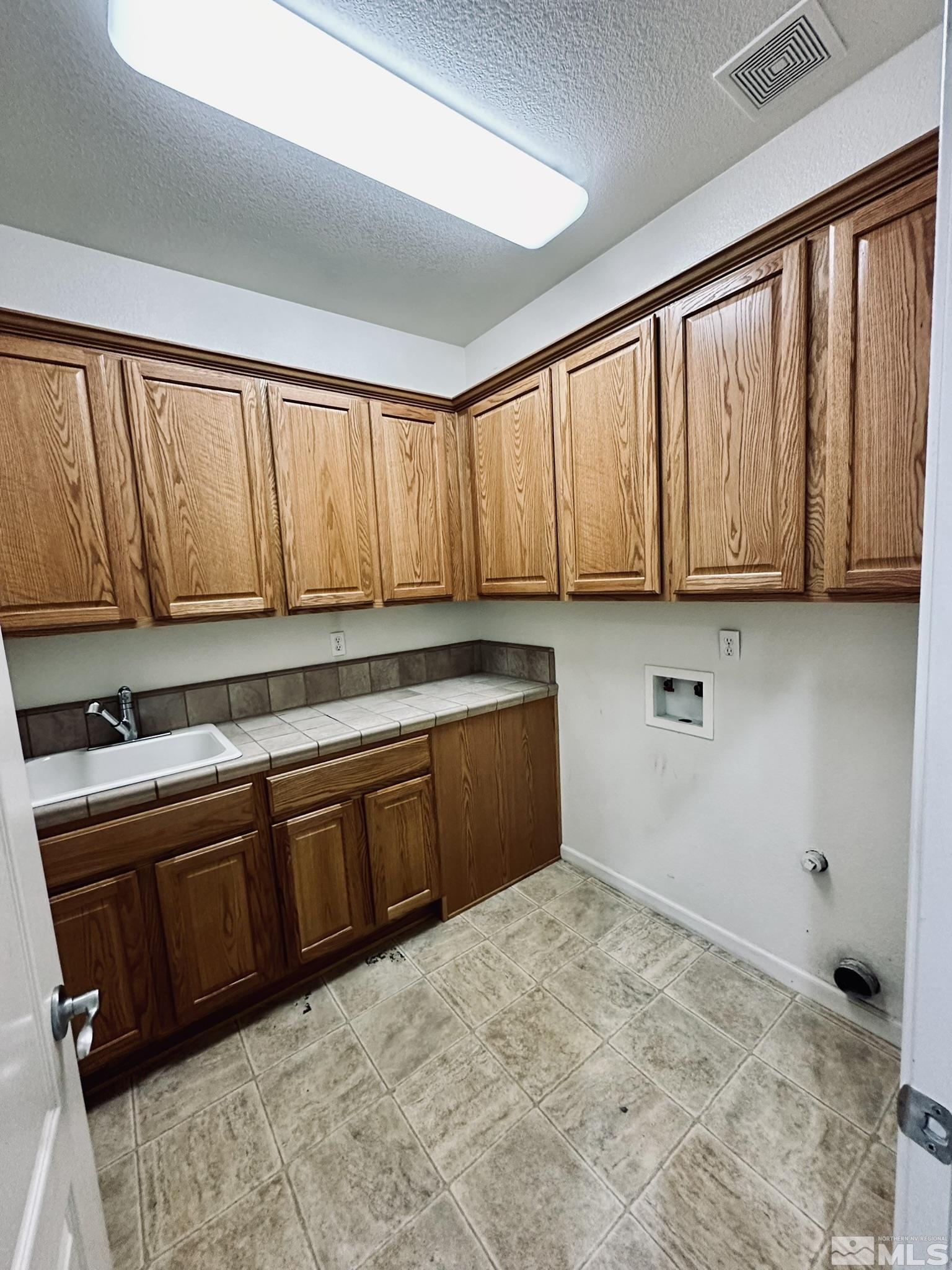 491 Oldenburg Drive Reno, NV 89521 - Photo 32 of 36 a kitchen with stainless steel appliances granite countertop a stove a sink dishwasher and cabinets with wooden floor