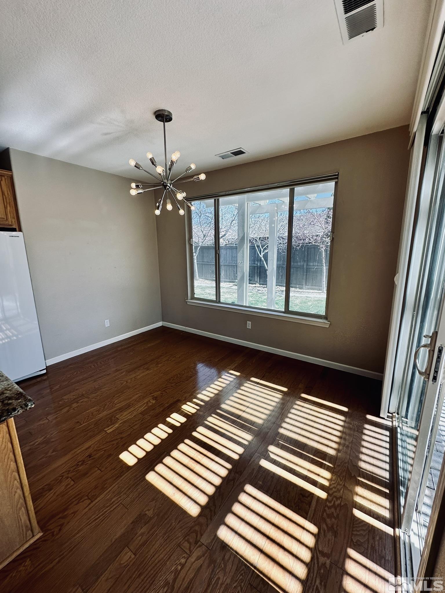 491 Oldenburg Drive Reno, NV 89521 - Photo 8 of 36 wooden floor in an empty room with a window