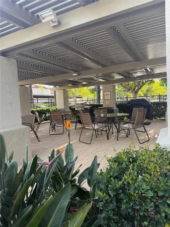 a view of a patio with table and chairs potted plants with wooden floor