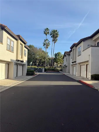 a view of a street with house on both side of it