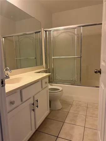 a bathroom with a granite countertop sink a toilet and shower