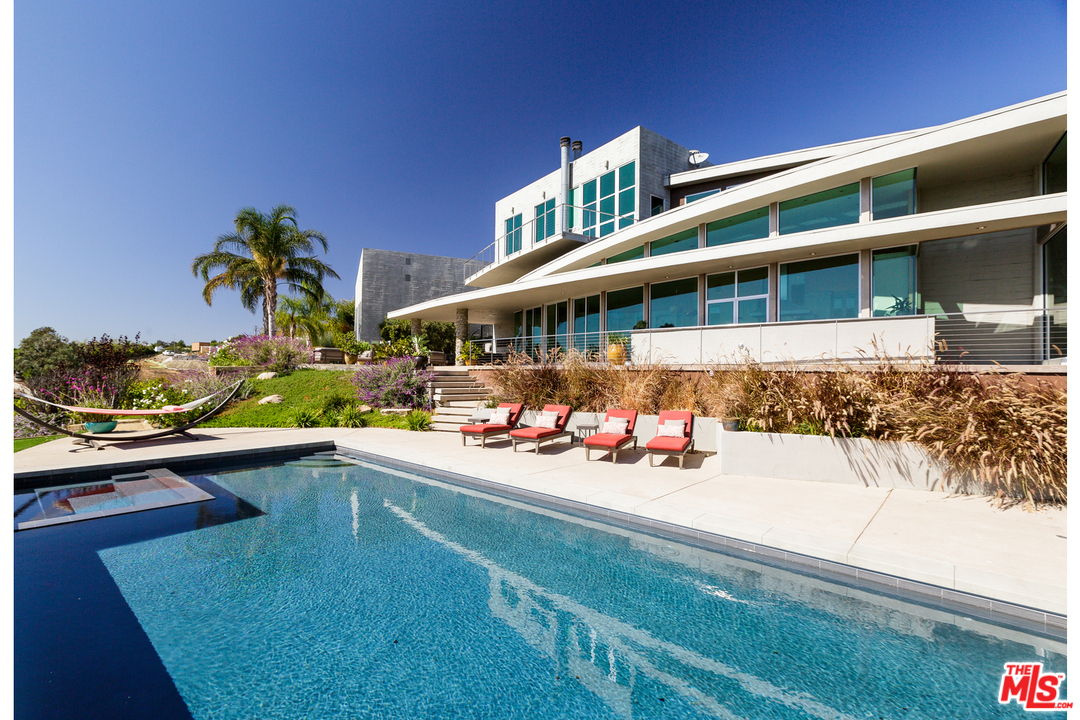 a view of a chairs and table on the balcony