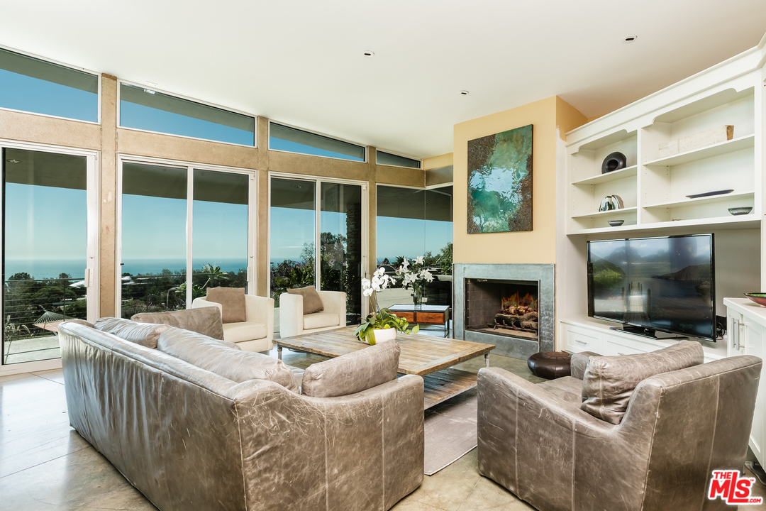27366 Winding Way Malibu, CA 90265 - Photo 12 of 43 a living room with fireplace furniture and a flat screen tv