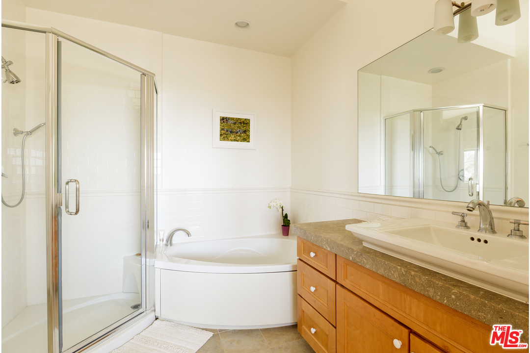 27366 Winding Way Malibu, CA 90265 - Photo 26 of 43 a bathroom with a granite countertop sink mirror and a bathtub