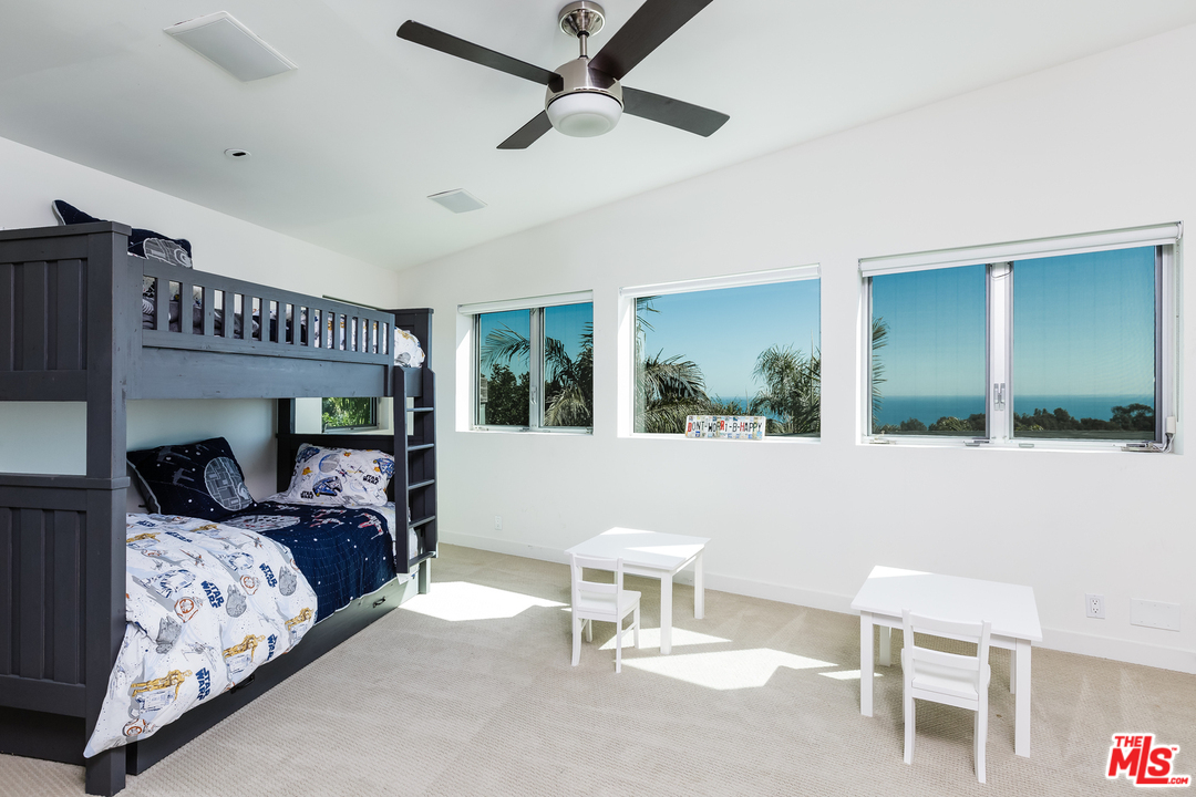 27366 Winding Way Malibu, CA 90265 - Photo 27 of 43 a bedroom with furniture and a large window