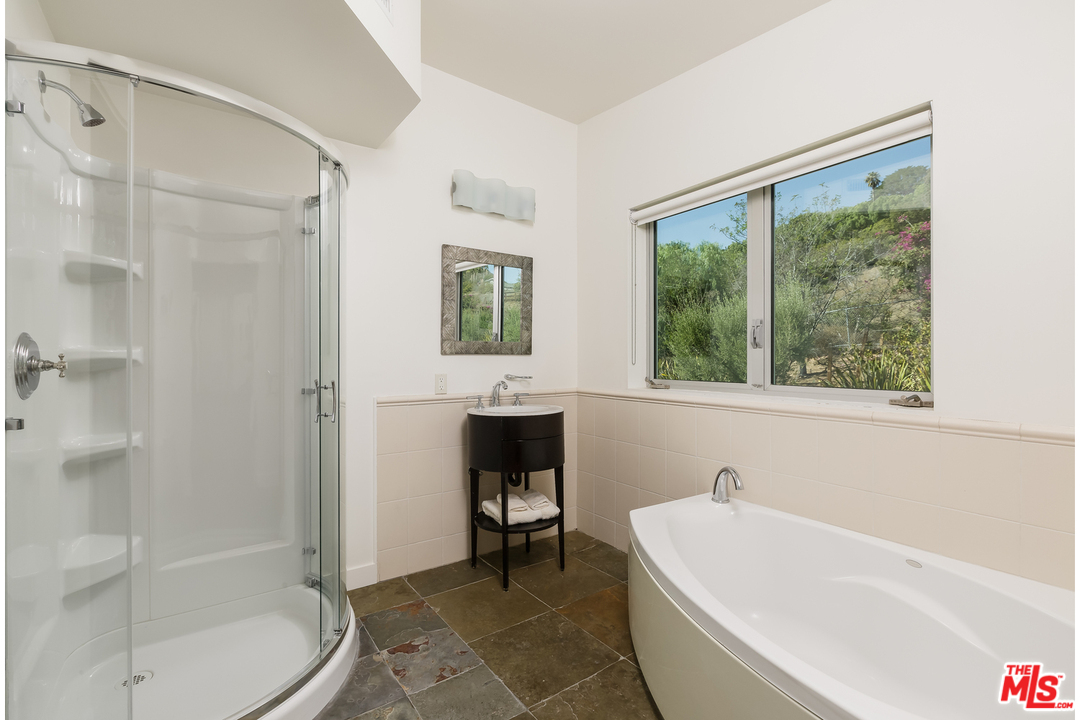27366 Winding Way Malibu, CA 90265 - Photo 28 of 43 a bathroom with a bathtub and a shower