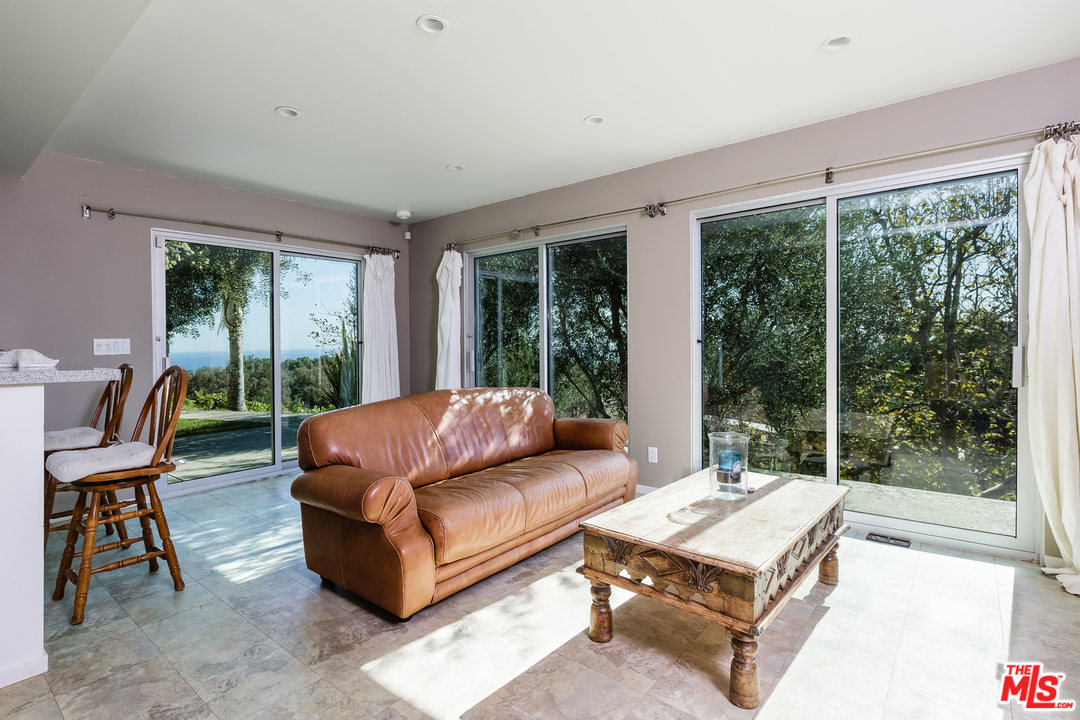 27366 Winding Way Malibu, CA 90265 - Photo 34 of 43 a living room with furniture and a large window