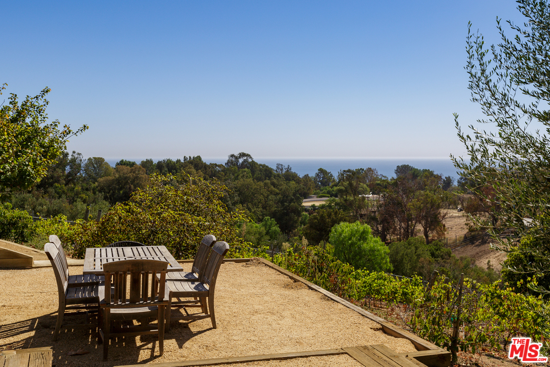 27366 Winding Way Malibu, CA 90265 - Photo 36 of 43 a view of a balcony with two chairs and a table