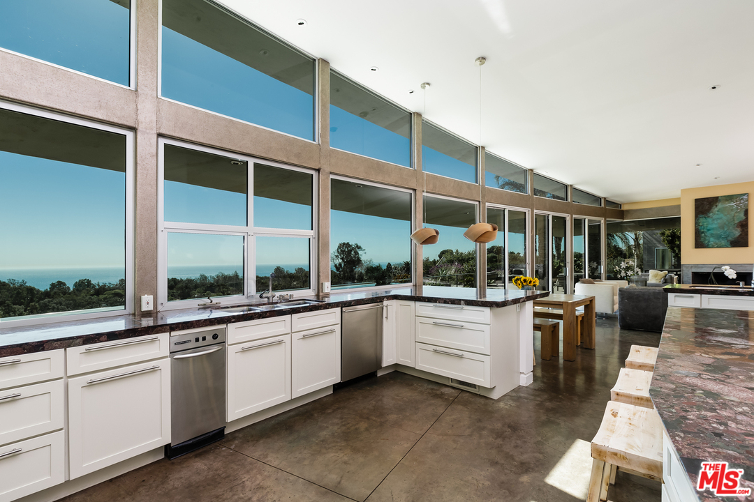 27366 Winding Way Malibu, CA 90265 - Photo 6 of 43 a kitchen with stainless steel appliances granite countertop a stove and more cabinets