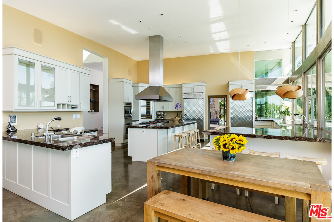 27366 Winding Way Malibu, CA 90265 - Photo 8 of 43 a kitchen with stainless steel appliances a sink a stove and white cabinets