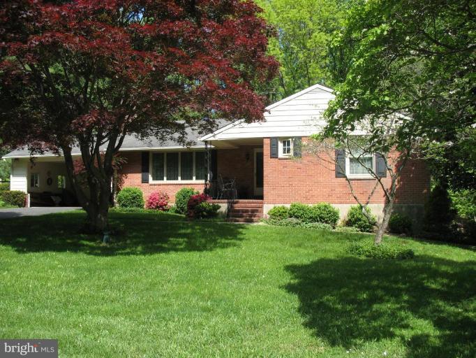 1604 Pinnacle Road Towson, MD 21286 - Photo 14 of 22 a front view of a house with a garden and trees