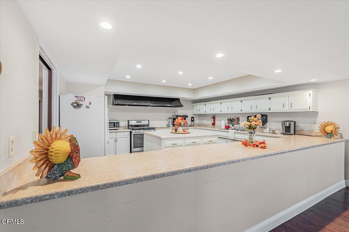 145 Ibsen Place, Unit 3 Oxnard, CA 93033 - Photo 42 of 47 a living room with lots of furniture and clutter