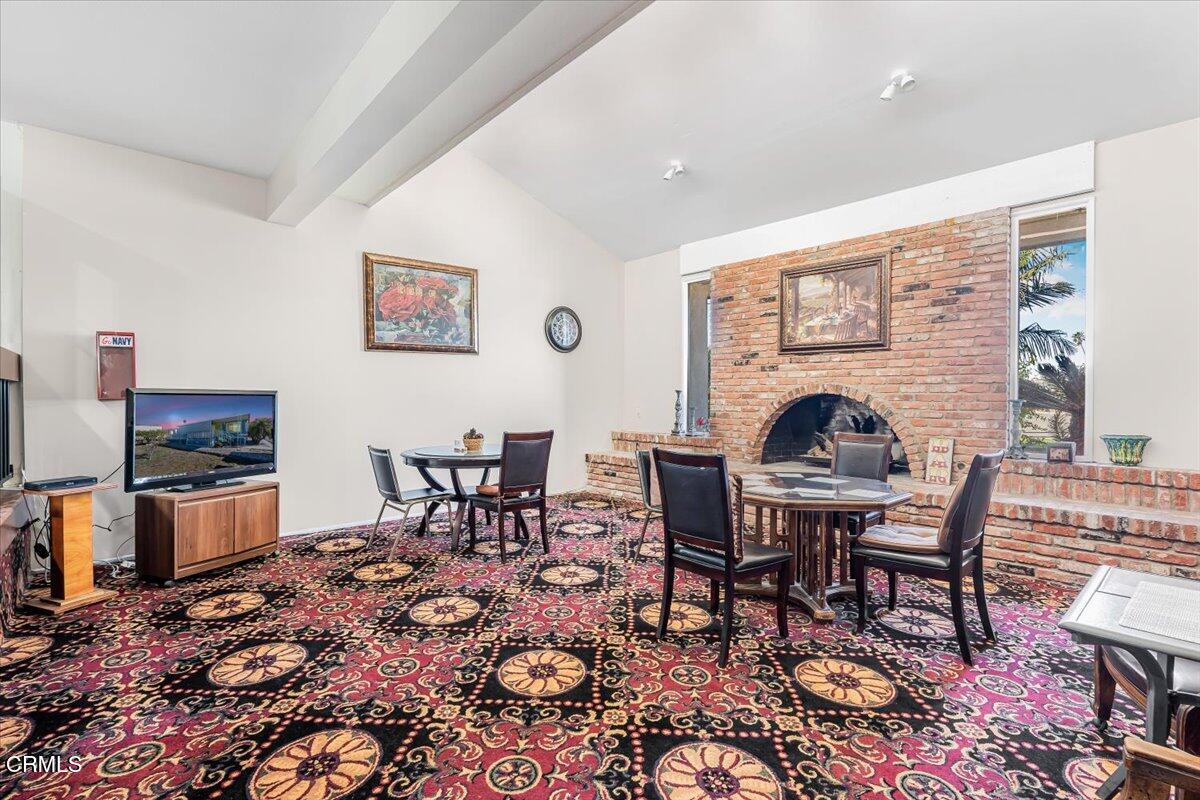 145 Ibsen Place, Unit 3 Oxnard, CA 93033 - Photo 44 of 47 a living room with furniture a rug and a flat screen tv