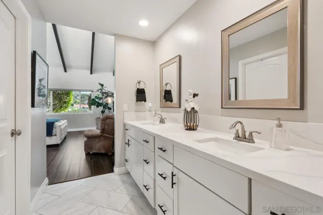 a en suite bathroom with double sink and a mirror