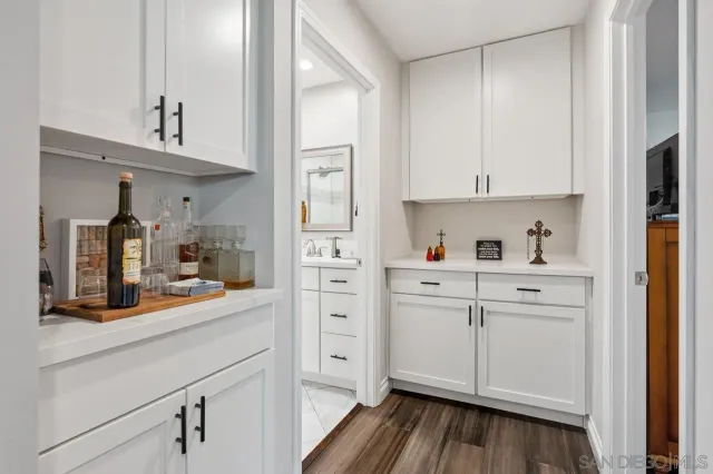 a kitchen with white cabinets and white appliances