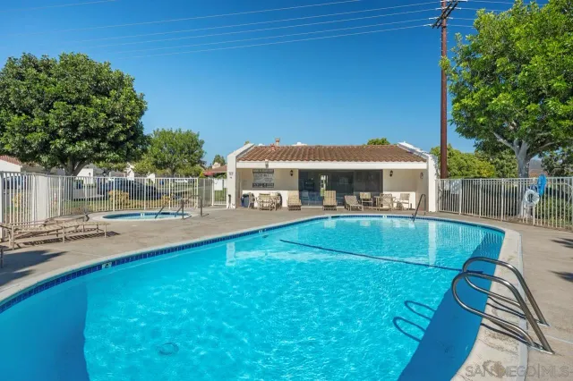 a view of house with outdoor space and swimming pool