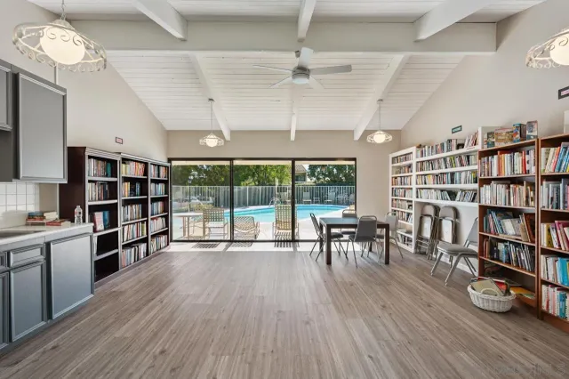 a living room with lots of furniture and a book shelf