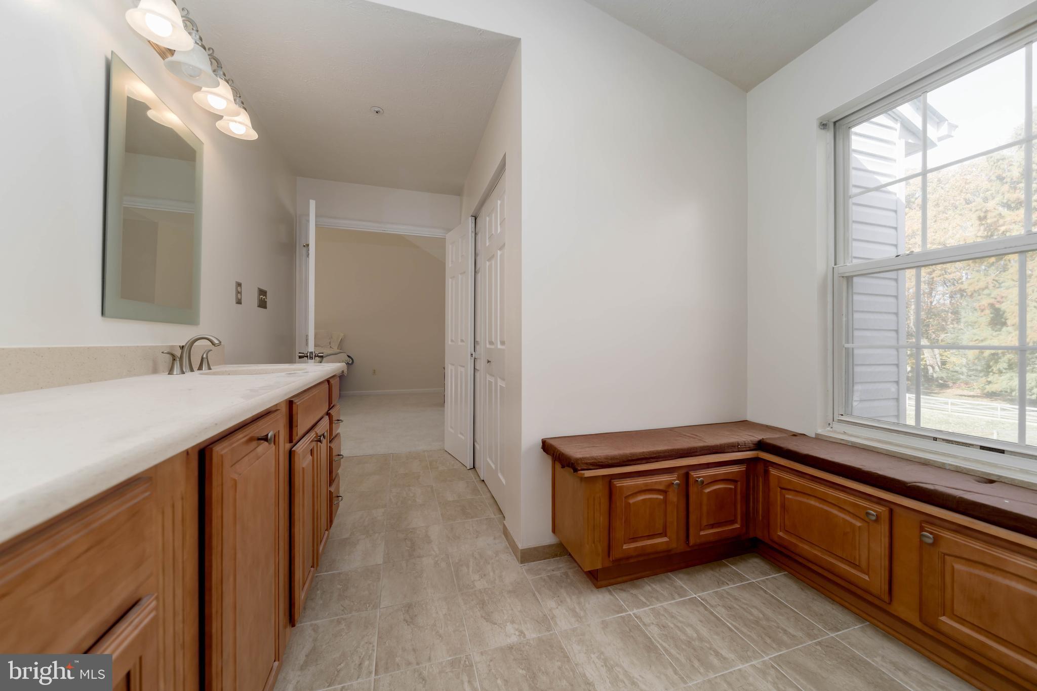 620 Small Reward Road Huntingtown, MD 20639 - Photo 17 of 33 a bathroom with a sink a vanity and a mirror