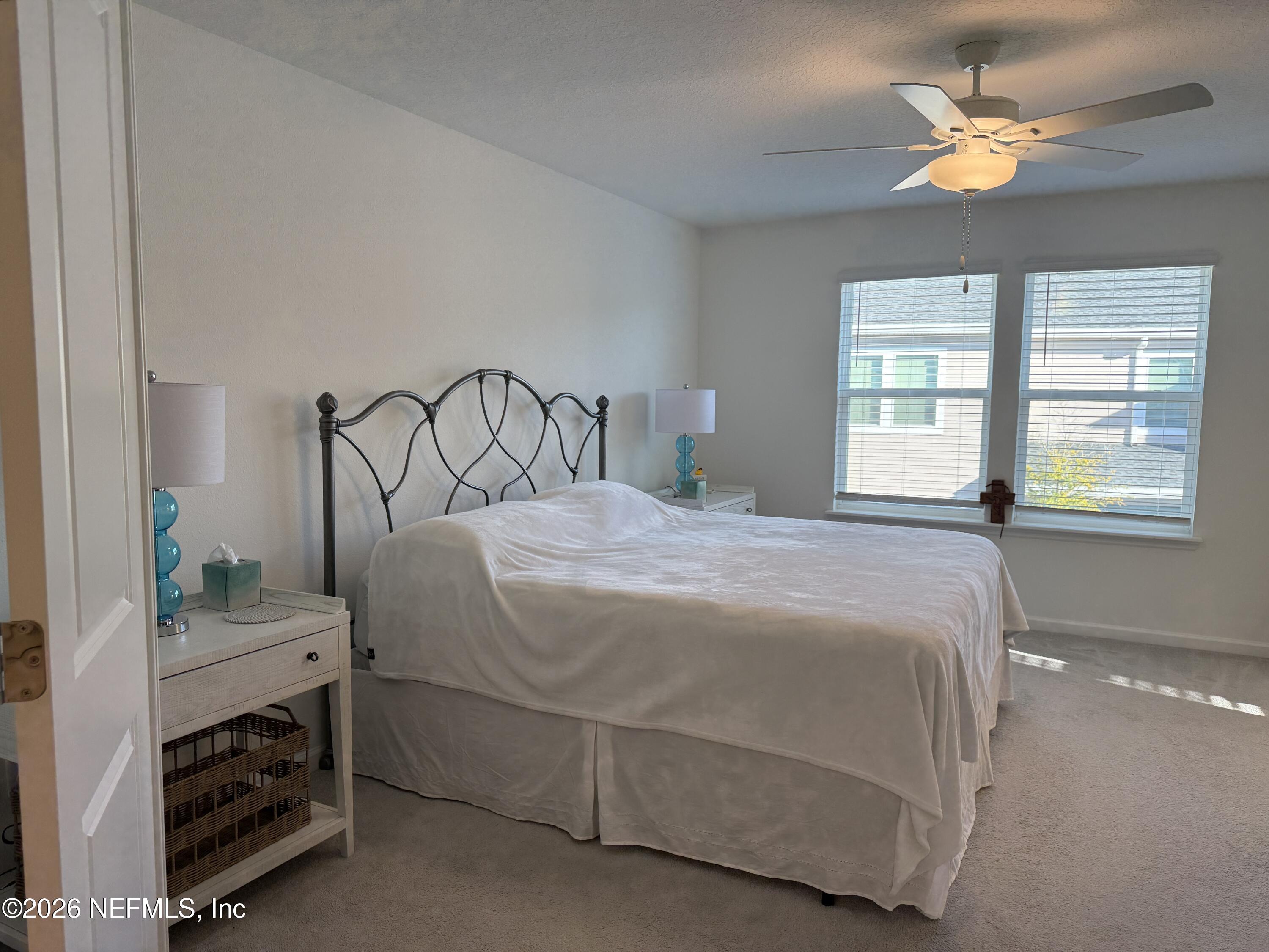 72 Bramble Court St. Augustine, FL 32092 - Photo 18 of 35 a bedroom with a bed and a chandelier