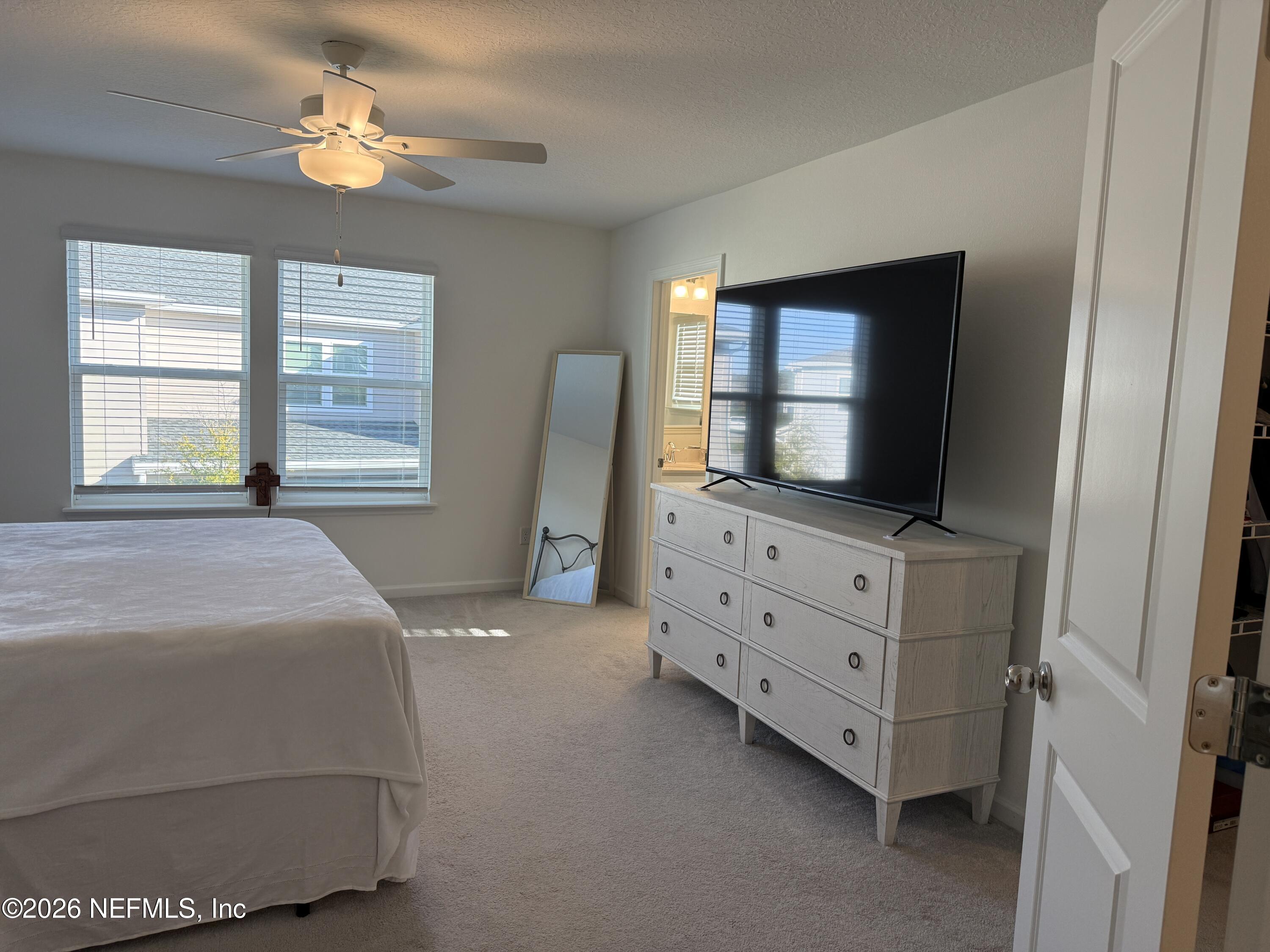 72 Bramble Court St. Augustine, FL 32092 - Photo 19 of 35 a bedroom with a bed and a flat screen tv