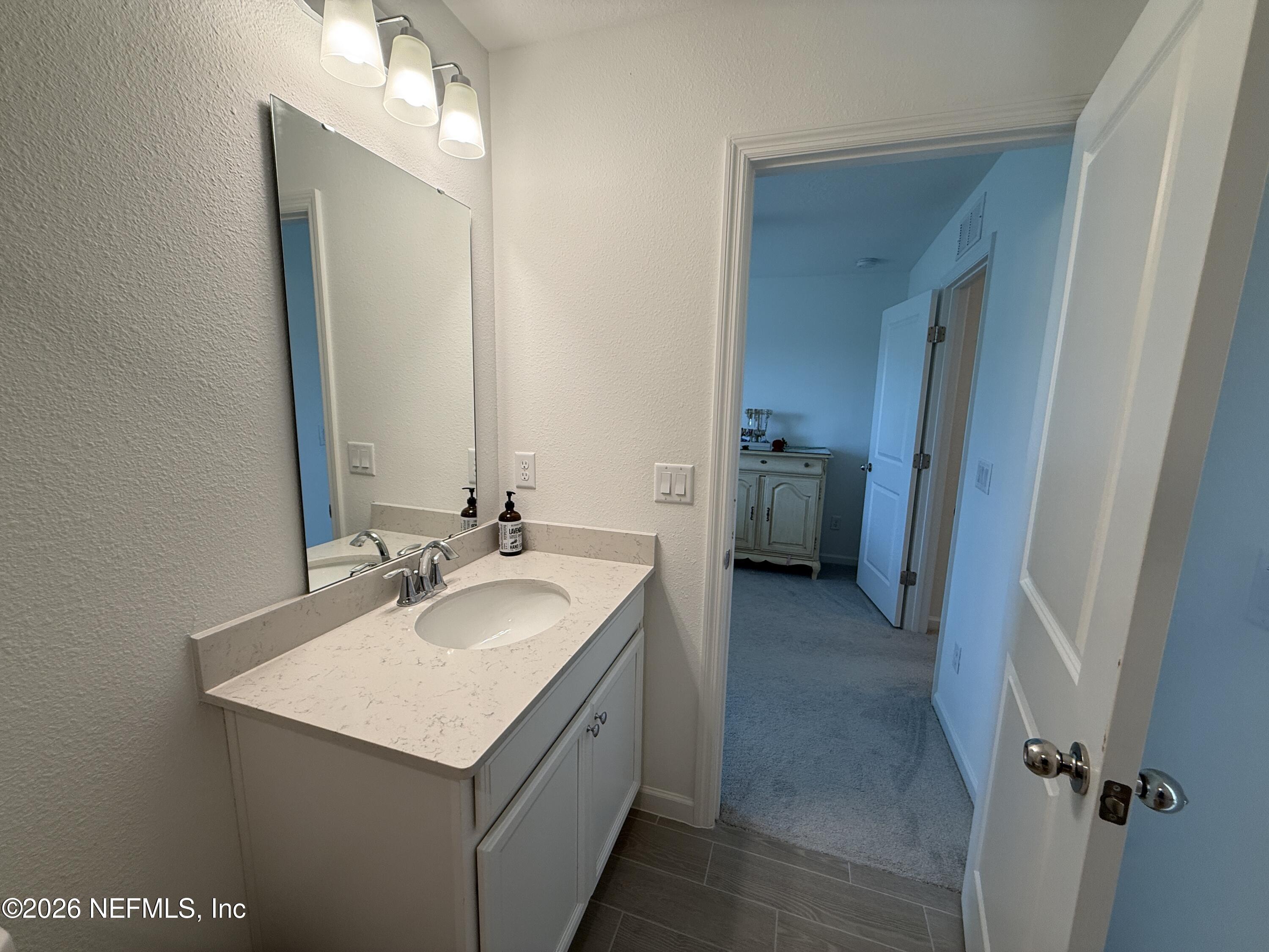 72 Bramble Court St. Augustine, FL 32092 - Photo 30 of 35 a bathroom with a sink and a mirror