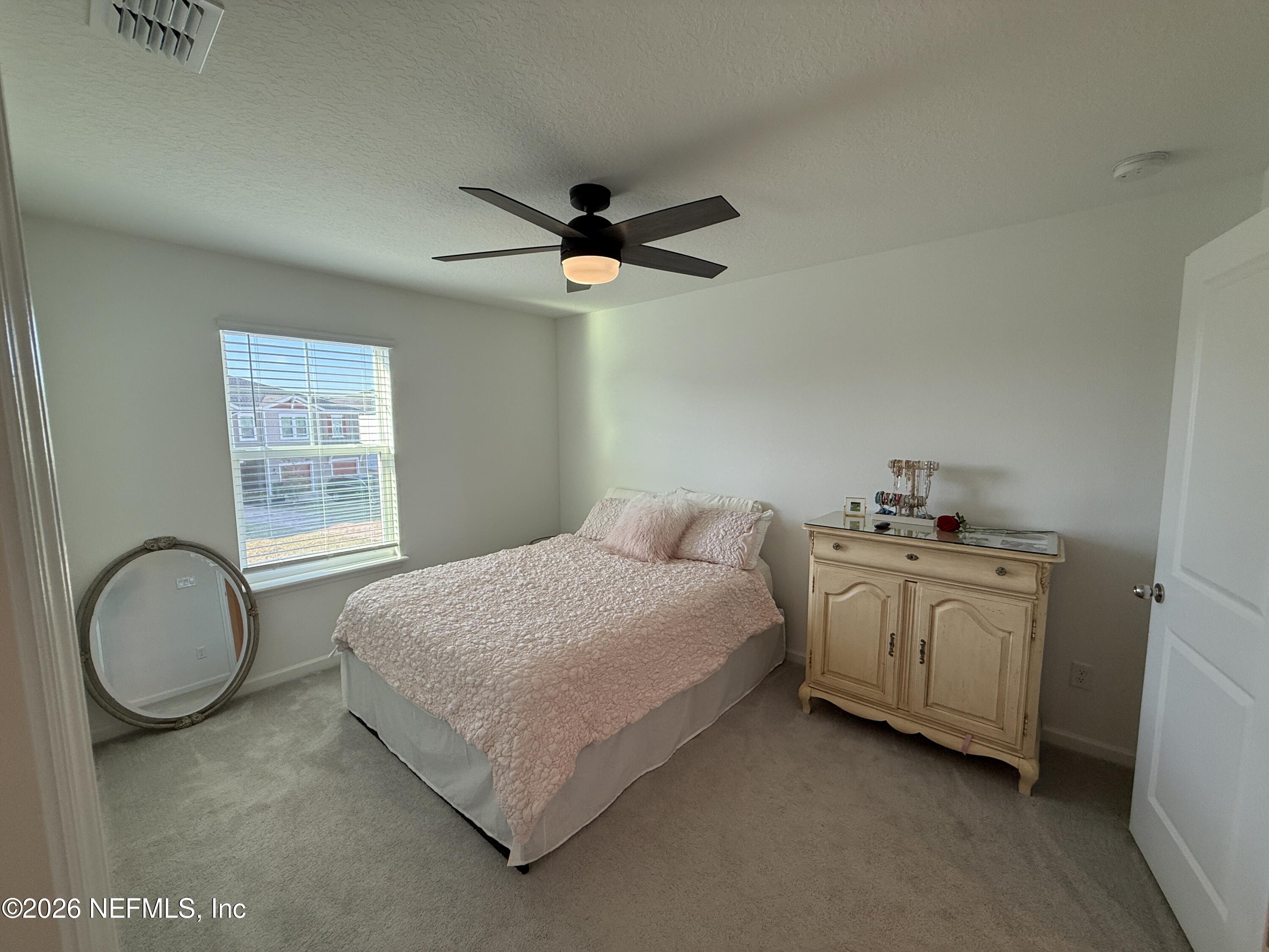 72 Bramble Court St. Augustine, FL 32092 - Photo 31 of 35 a bedroom with a bed dresser and a window