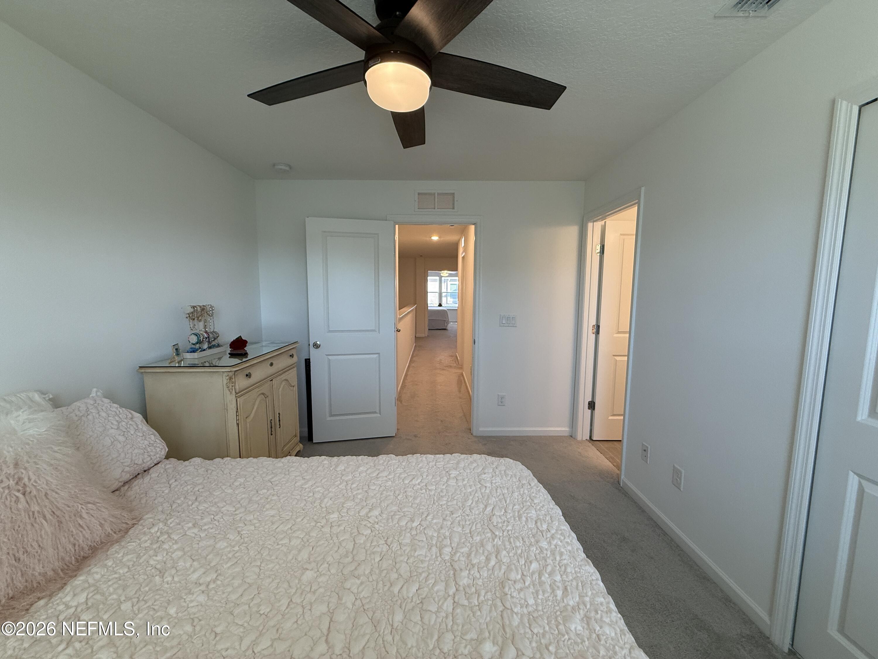 72 Bramble Court St. Augustine, FL 32092 - Photo 33 of 35 a bedroom with a bed and a large mirror next to a window