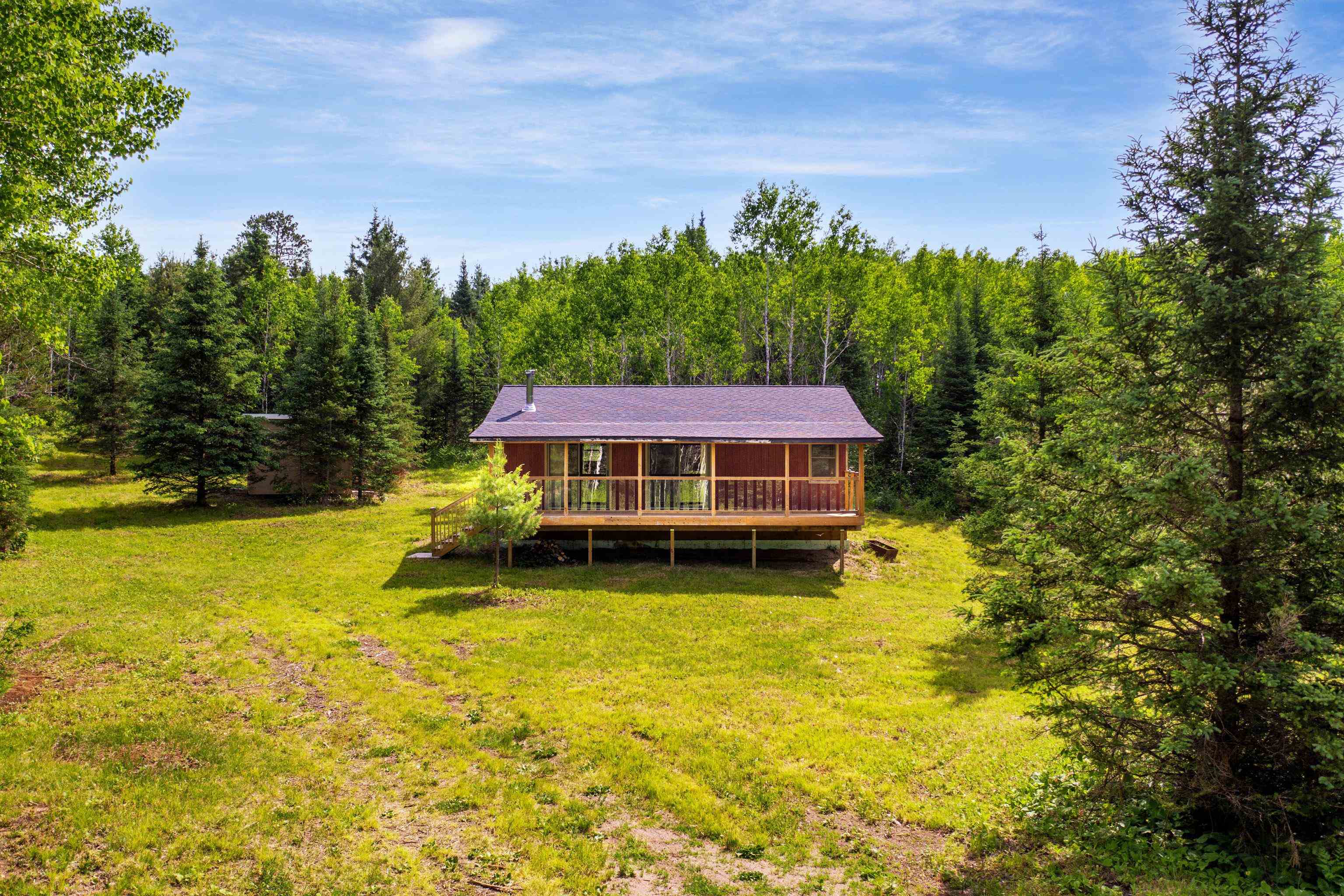1612 Pequaywan Lake Road Brimson, MN 55602 - Photo 5 of 45 Rear view of property featuring a wooded view, a yard, and a wooden deck