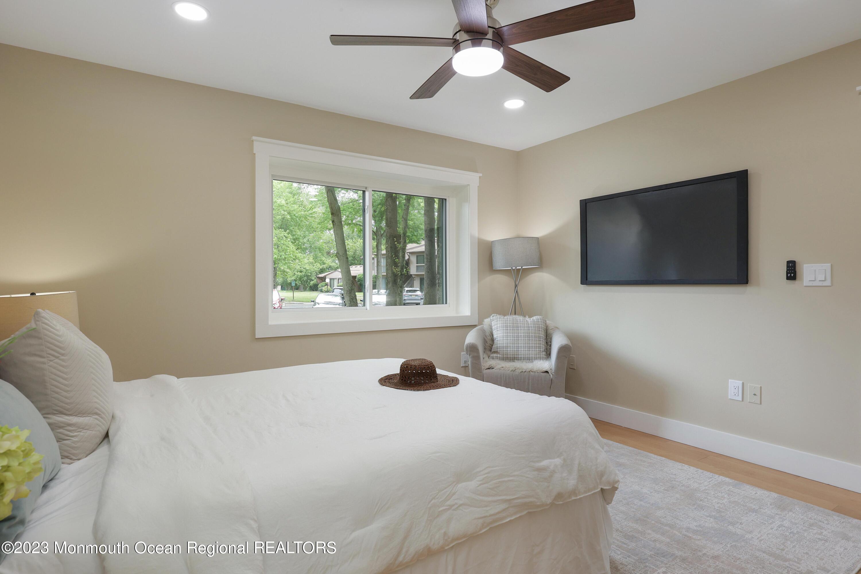 29 Manchester Court Red Bank, NJ 07701 - Photo 31 of 49 a bedroom with a bed and a flat screen tv