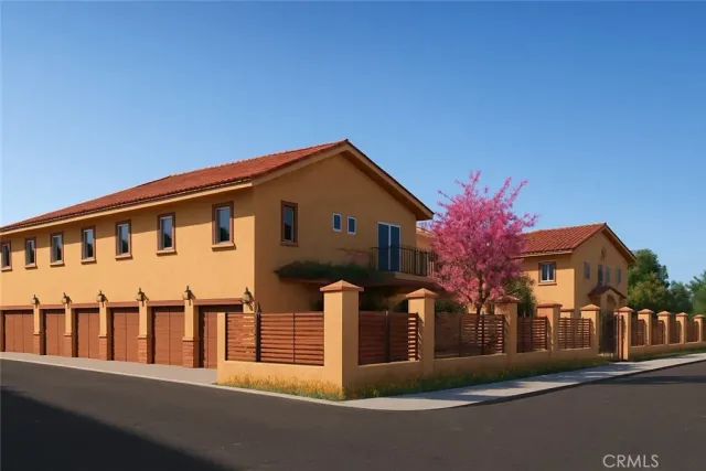 a front view of house with yard and trees in the background