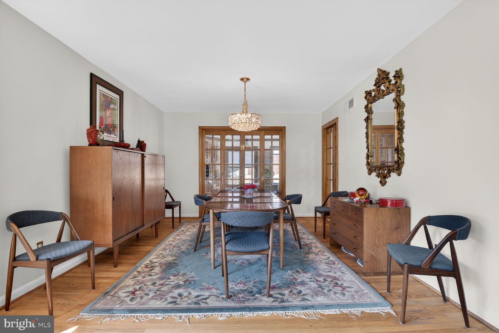 5800 Plainview Road Bethesda, MD 20817 - Photo 5 of 30 a dining room with furniture a rug and a chandelier