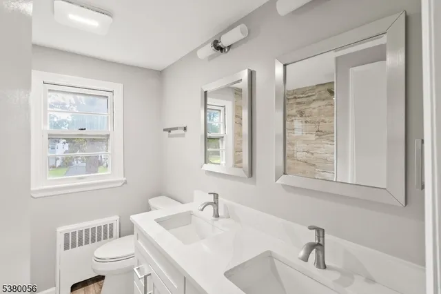 a bathroom with a sink toilet vanity and tub