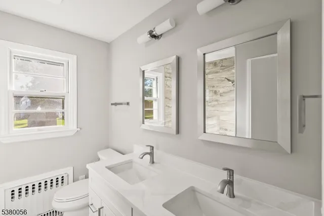 a bathroom with a sink toilet and a mirror