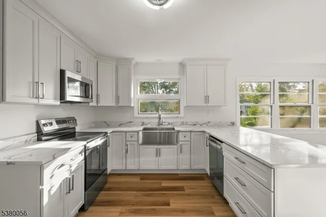 a kitchen with a sink stove and cabinets