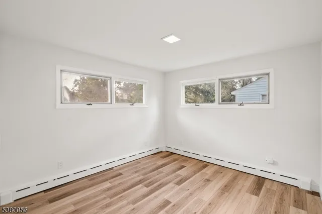 a view of a room with wooden floor and window