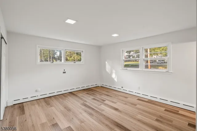 a view of a room with wooden floor and window