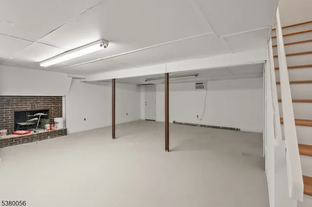 an empty room with a fireplace and a window