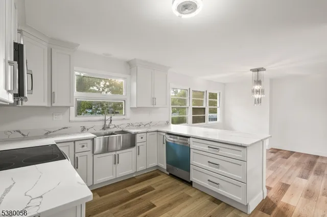 a kitchen with a sink stove and cabinets