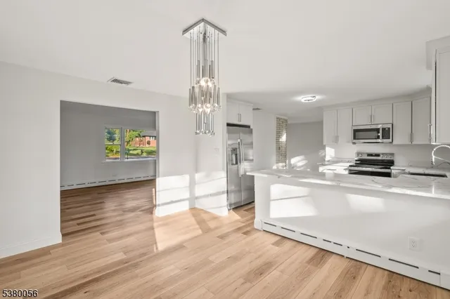 a view of a kitchen with microwave and cabinets