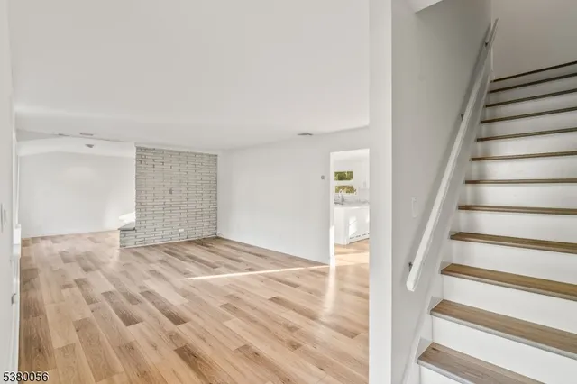 a view of an empty room and stairs