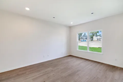 a view of room with window and wooden floor
